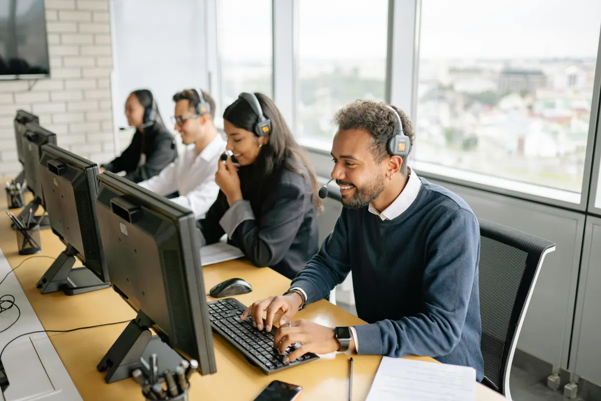 Remote customer service professionals working at their desks wearing headsets
